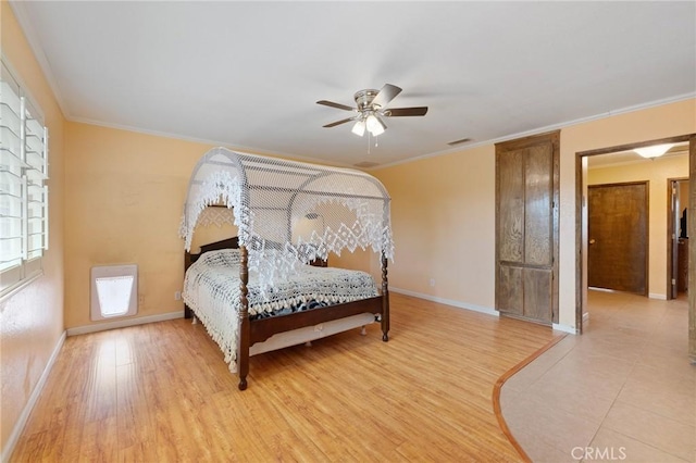 bedroom featuring crown molding, ceiling fan, and light wood-type flooring