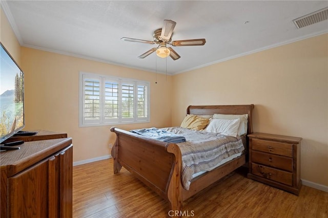 bedroom featuring ceiling fan, ornamental molding, and light hardwood / wood-style floors