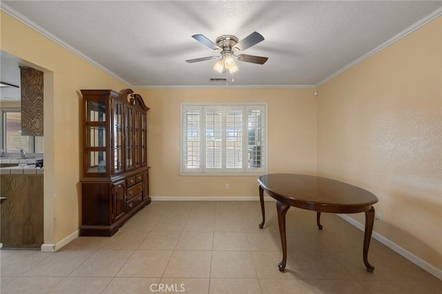 tiled dining room featuring crown molding and ceiling fan