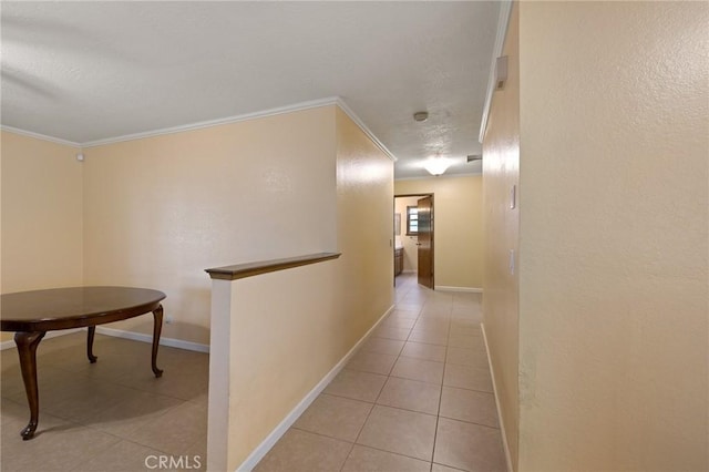 hall featuring ornamental molding and light tile patterned floors