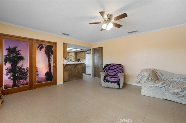 living area featuring ornamental molding and ceiling fan