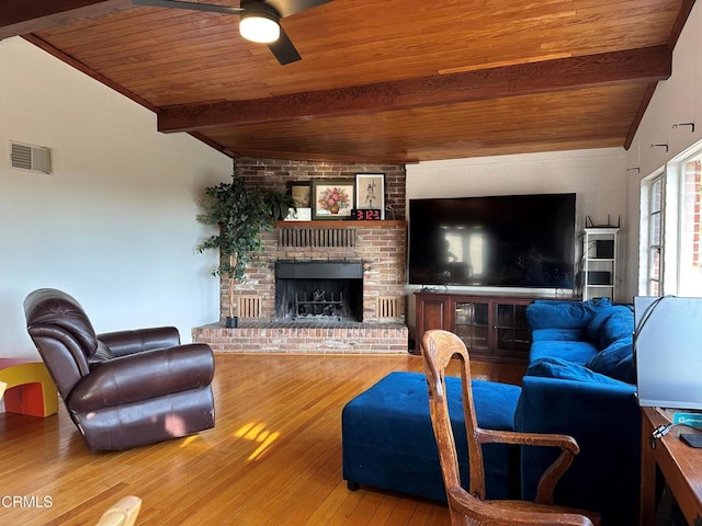 living room with a brick fireplace, wood ceiling, wood-type flooring, and ceiling fan