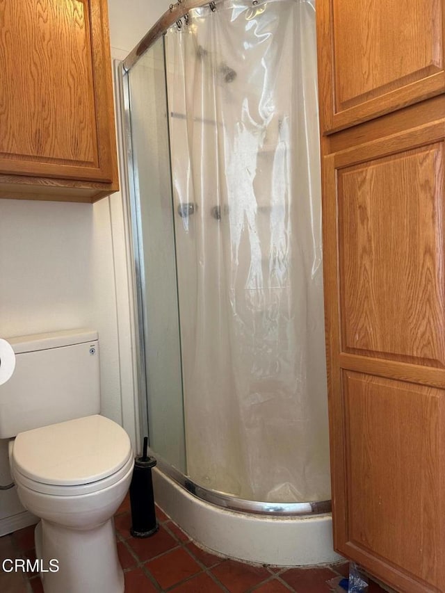 bathroom featuring a shower with door and tile patterned floors