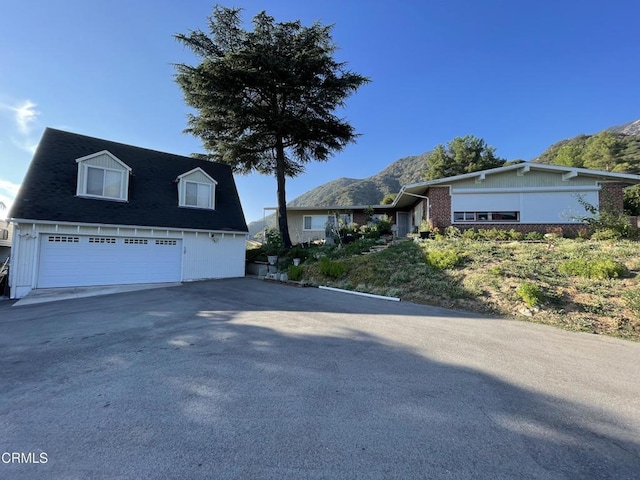 view of front facade featuring a garage and a mountain view