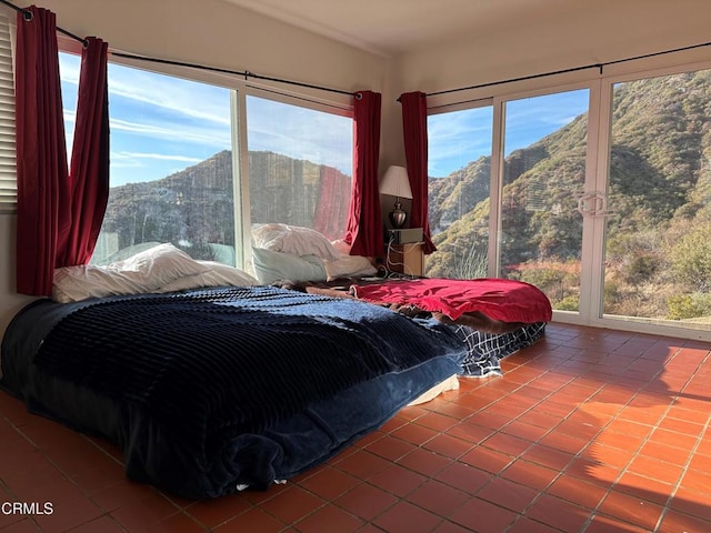 bedroom featuring tile patterned flooring and a mountain view