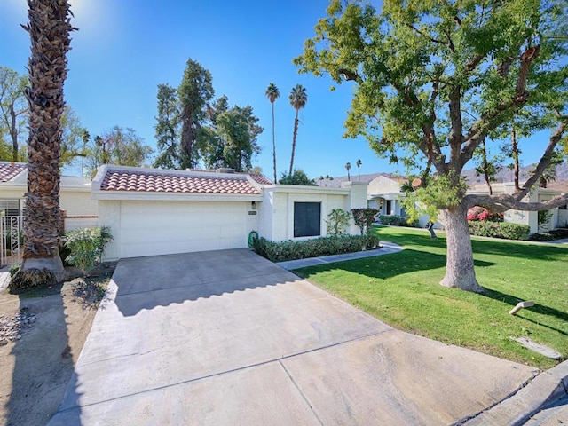 view of front of property featuring a garage and a front lawn