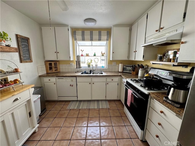 kitchen with white cabinetry, dishwasher, sink, tile patterned flooring, and gas range