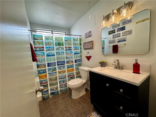 bathroom with tile patterned floors, toilet, a textured ceiling, vanity, and a shower with shower curtain