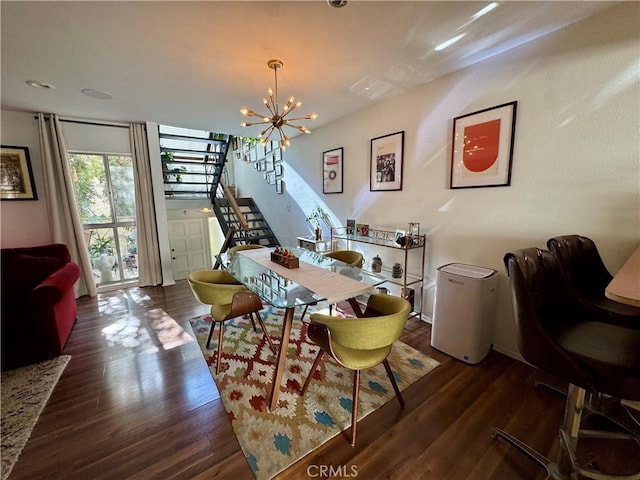 dining area featuring dark hardwood / wood-style floors and a chandelier