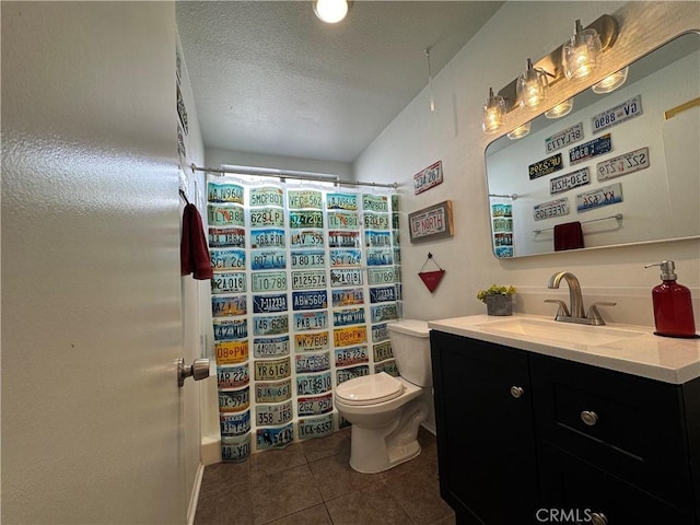 bathroom featuring a textured ceiling, tile patterned floors, toilet, and a shower with shower curtain