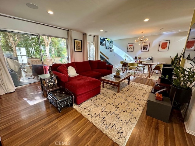 living room featuring wood-type flooring and a chandelier