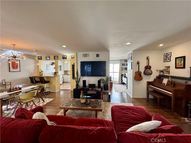 living room with hardwood / wood-style flooring and a chandelier