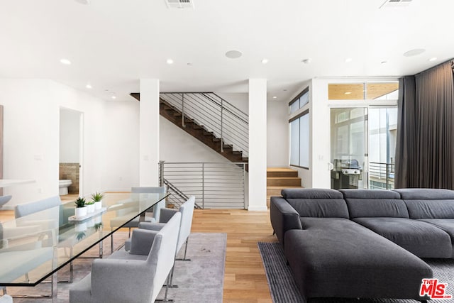 living room featuring floor to ceiling windows and light wood-type flooring