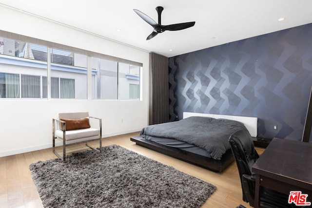 bedroom featuring light hardwood / wood-style flooring and ceiling fan