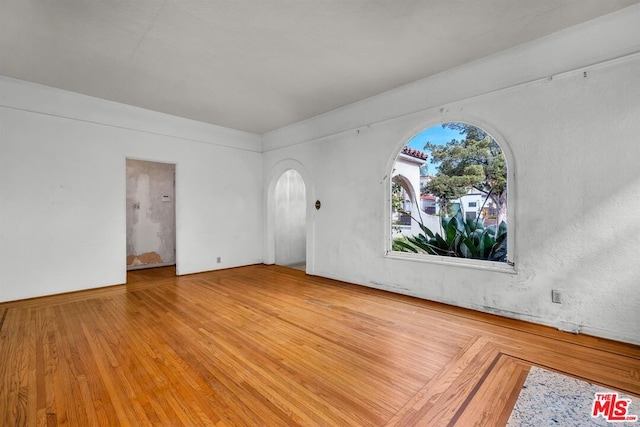 unfurnished room with hardwood / wood-style flooring