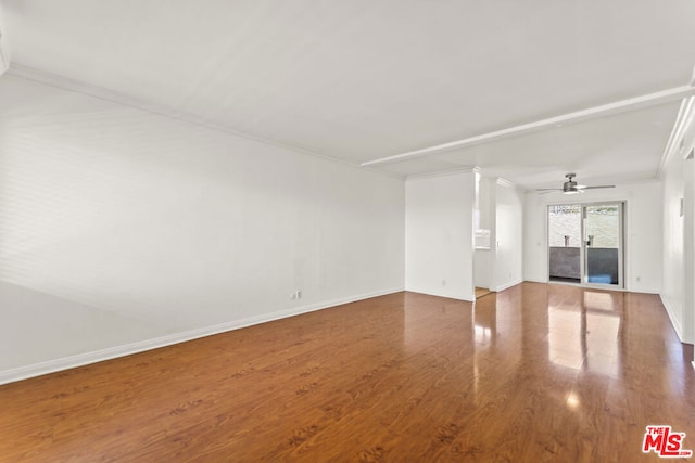 empty room featuring crown molding, ceiling fan, and wood-type flooring