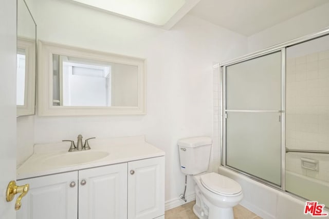 full bathroom with enclosed tub / shower combo, vanity, toilet, and tile patterned flooring