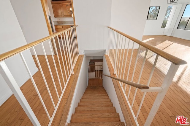 stairs featuring hardwood / wood-style flooring