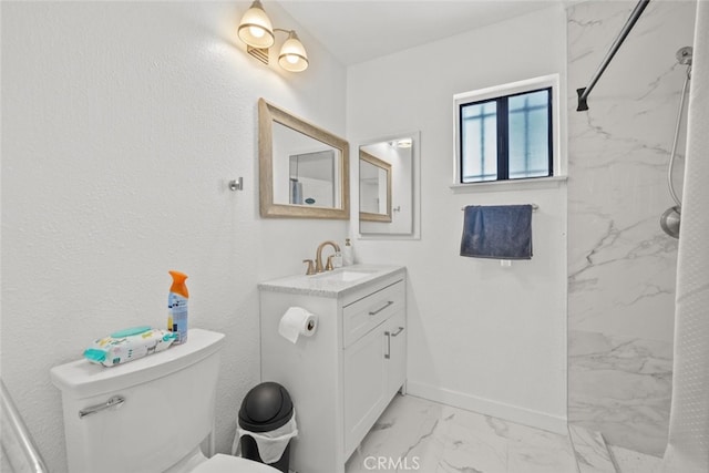 bathroom featuring vanity, walk in shower, and toilet