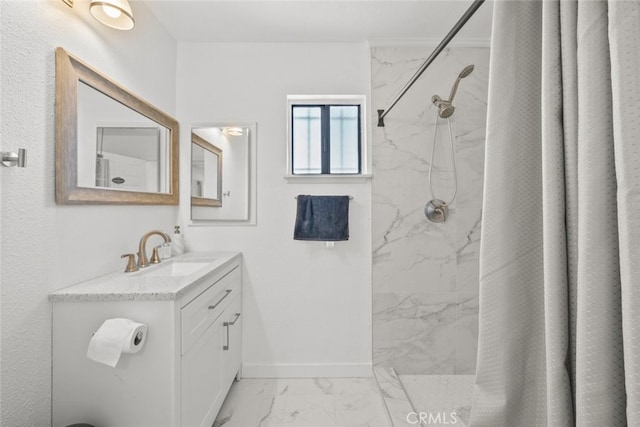 bathroom with vanity and tiled shower