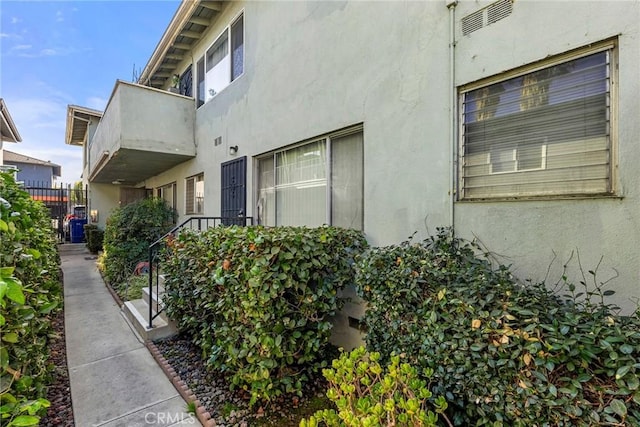 view of side of home featuring a balcony