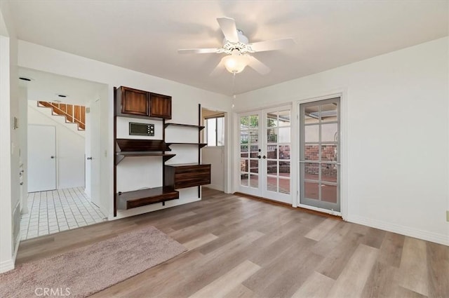 interior space with french doors, ceiling fan, and light hardwood / wood-style floors