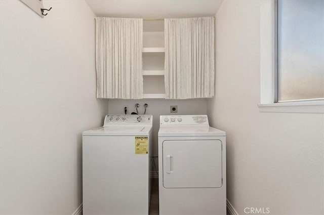 laundry room with cabinets and washing machine and dryer