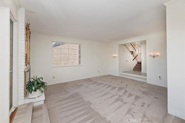 carpeted spare room featuring crown molding