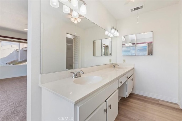 bathroom with vanity and hardwood / wood-style floors