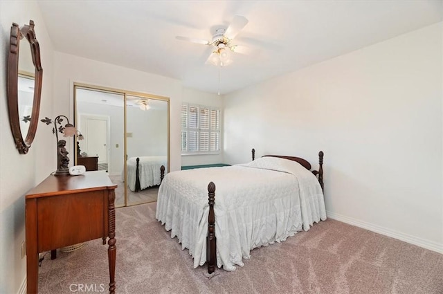 carpeted bedroom featuring ceiling fan and a closet