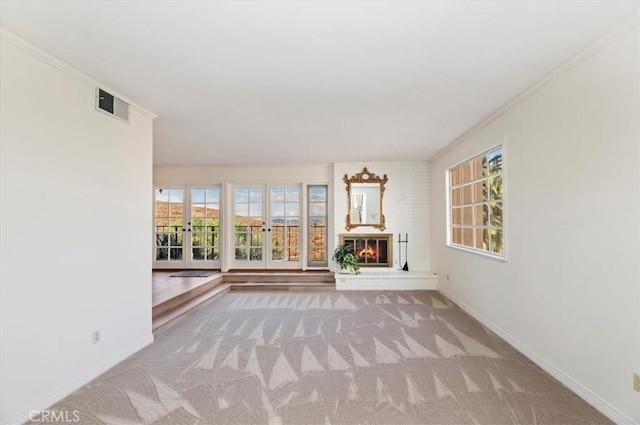 unfurnished sunroom featuring plenty of natural light and a fireplace