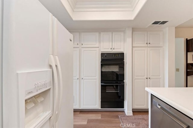 kitchen featuring white cabinetry, double oven, white refrigerator with ice dispenser, and dishwasher