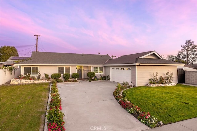 ranch-style house with a yard and a garage