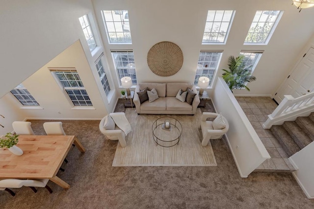 living room featuring light tile patterned flooring and a towering ceiling