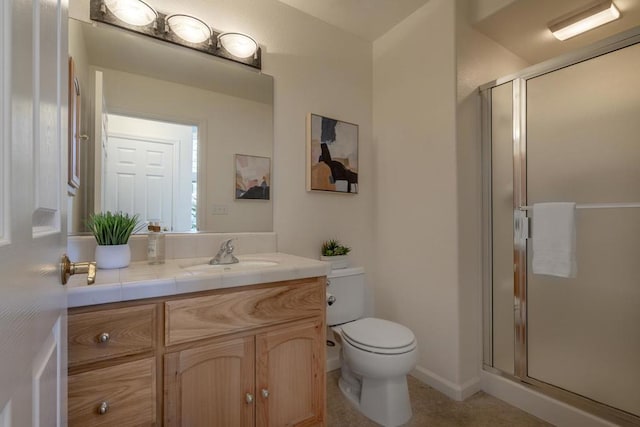 bathroom featuring an enclosed shower, vanity, and toilet