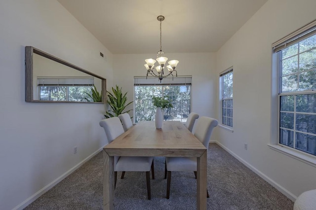 unfurnished dining area with a notable chandelier and dark carpet