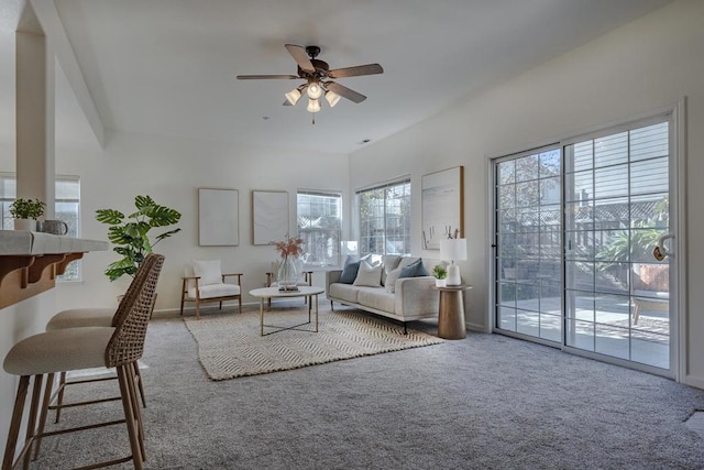 carpeted living room featuring ceiling fan