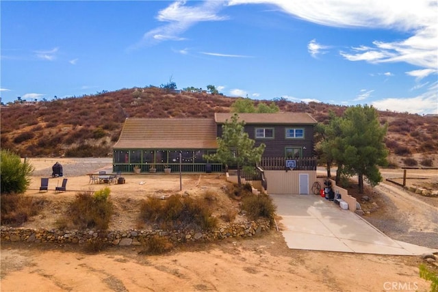 view of front of property with concrete driveway and fence