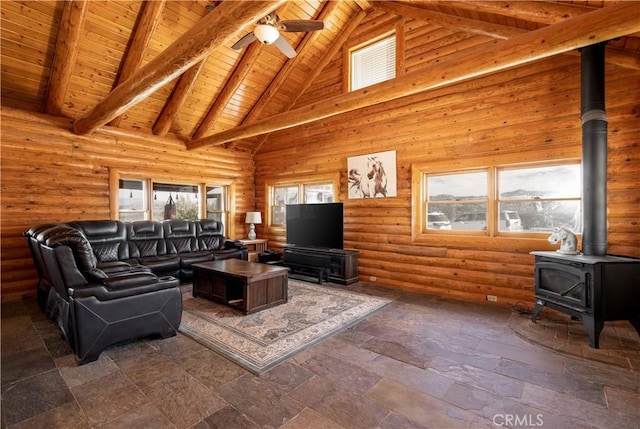 living area featuring a wood stove, high vaulted ceiling, wood ceiling, beam ceiling, and ceiling fan