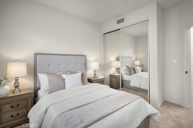 bedroom featuring light carpet and a closet