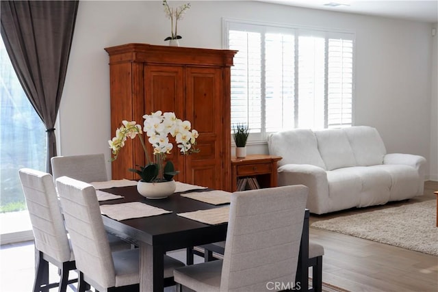 dining room featuring a healthy amount of sunlight and light wood-type flooring