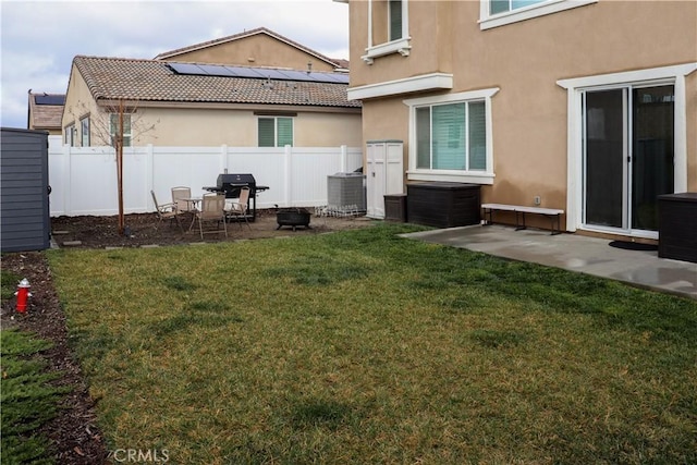 rear view of property with central AC unit, a patio, and a lawn