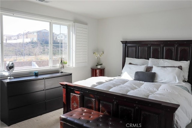 bedroom with light colored carpet