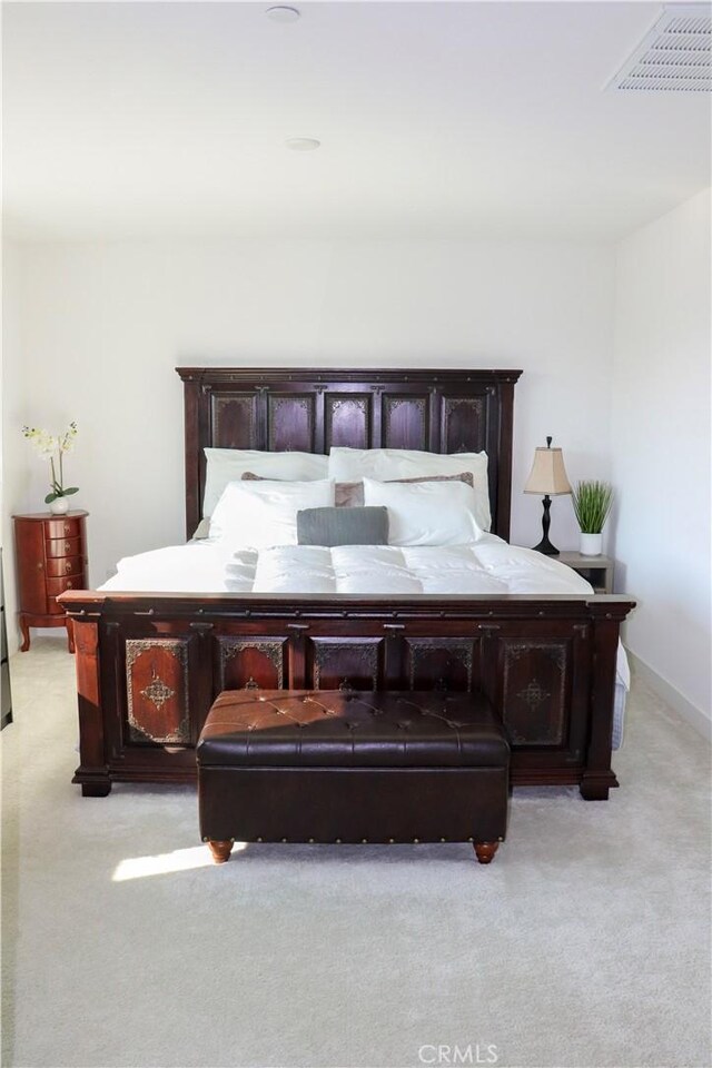 bedroom featuring light carpet