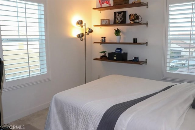 bedroom featuring multiple windows and light colored carpet