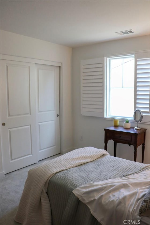 carpeted bedroom featuring a closet