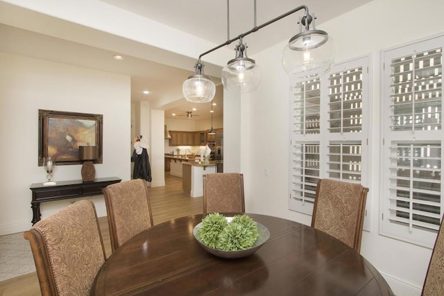 dining space with light hardwood / wood-style flooring