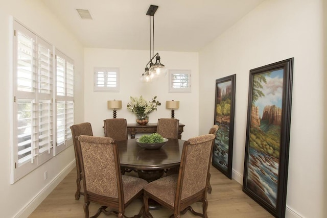 dining area with light hardwood / wood-style floors