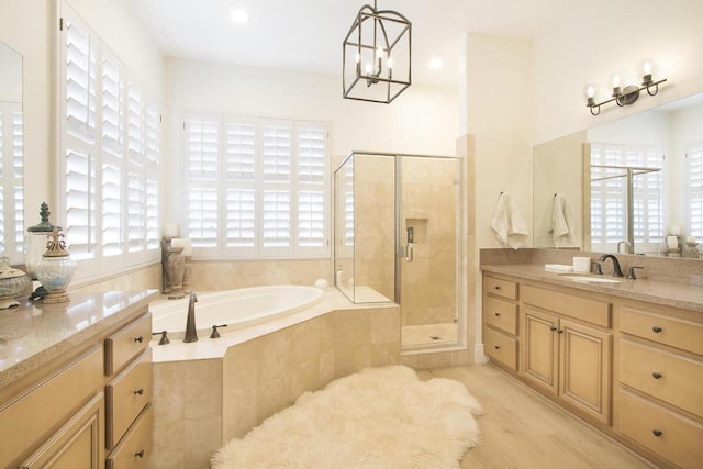 bathroom with vanity, plenty of natural light, and plus walk in shower