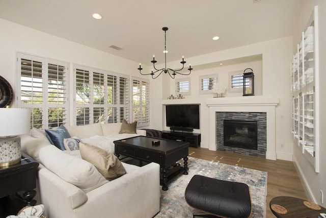 living room with an inviting chandelier and hardwood / wood-style floors